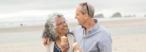 Adorable senior couple enjoy each other's company and ice cream cones on an Oregon beach.