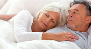 Sleeping couple happy their dentures are protected by sleep appliances at night