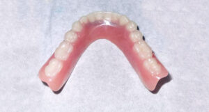 The underside of a shiny new lower denture